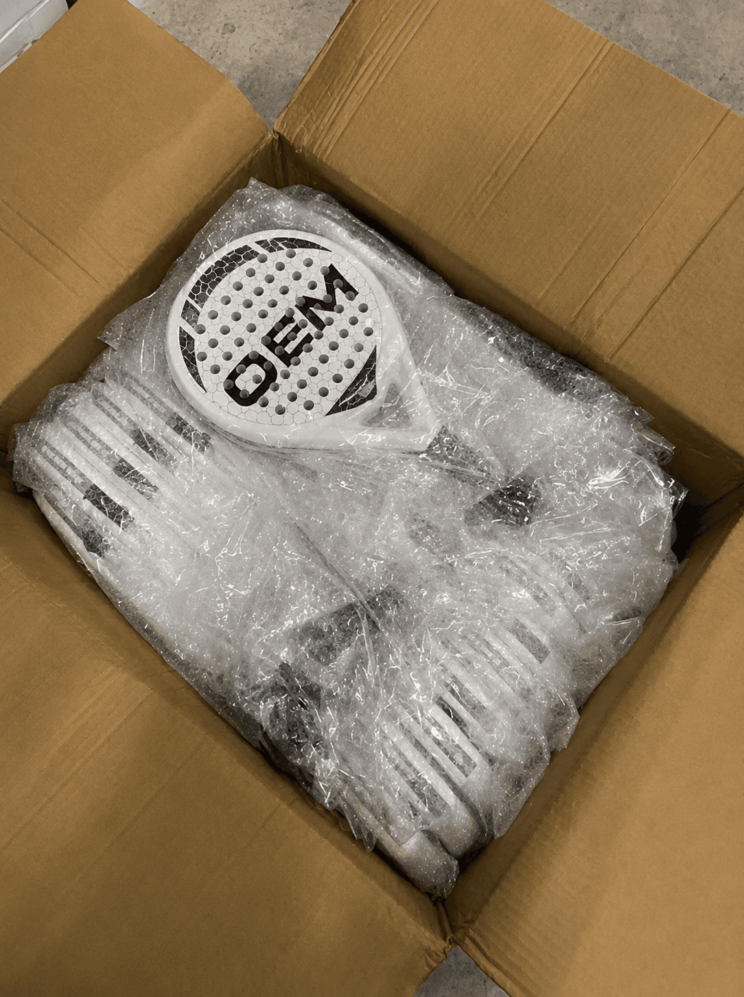 Padel racket carefully bubble-wrapped and boxed for shipment