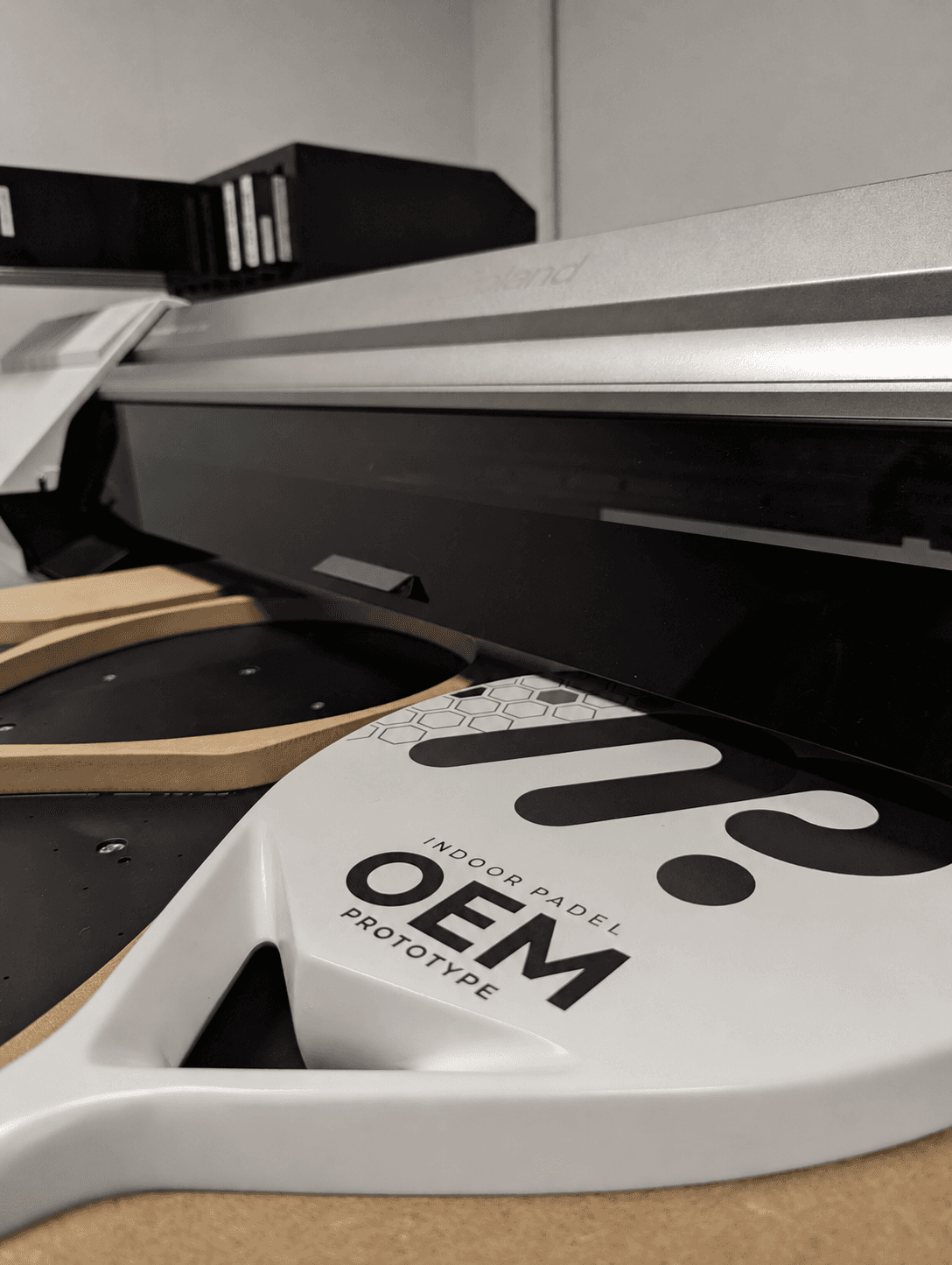 Finished padel racket prototypes and a precision mold on the factory floor